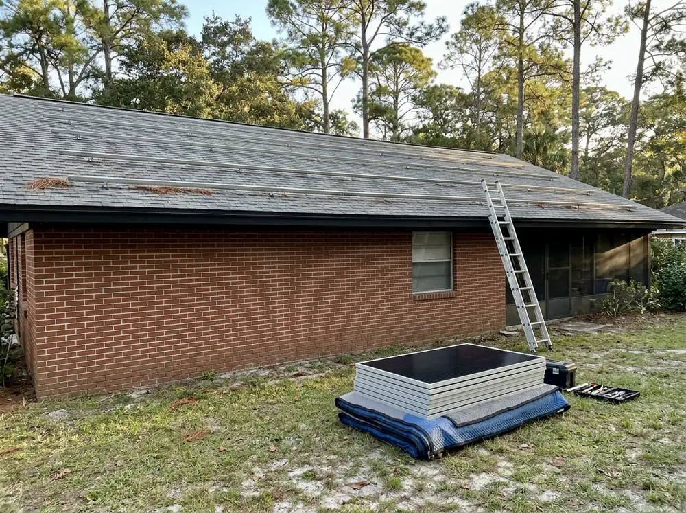 Bare roof racking rails left on a shingle roof after solar panels were removed for a reroof